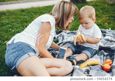 Mother with son playing in a summer park 54058574