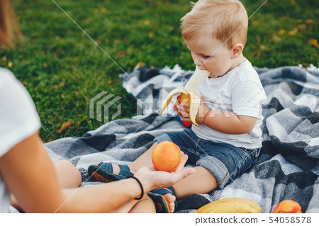 Mother with son playing in a summer park Mother with son playing in a summer park 54058578