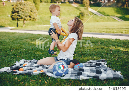 Mother with son playing in a summer park Mother with son playing in a summer park 54058695
