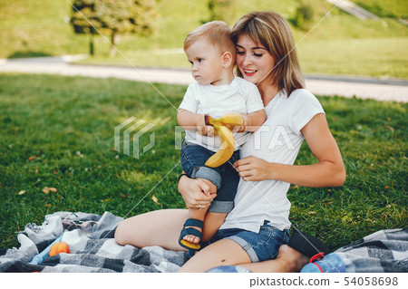 Mother with son playing in a summer park Mother with son playing in a summer park 54058698