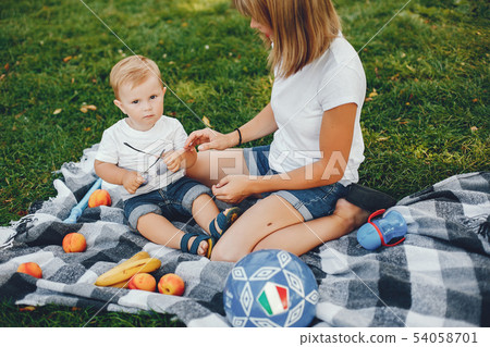 Mother with son playing in a summer park Mother with son playing in a summer park 54058701