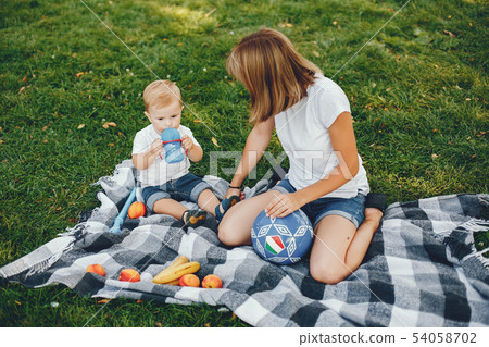 Mother with son playing in a summer park Mother with son playing in a summer park 54058702