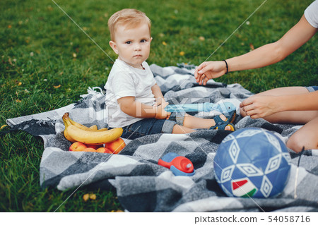 Mother with son playing in a summer park Mother with son playing in a summer park 54058716