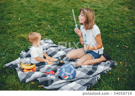 Mother with son playing in a summer park 54058719