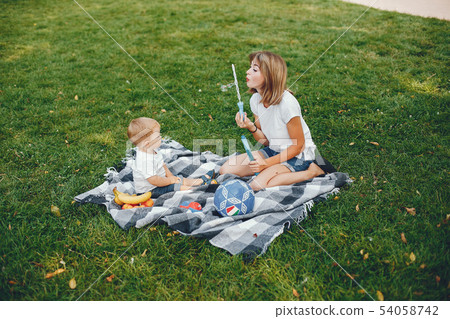 Mother with son playing in a summer park 54058742