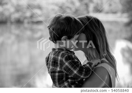 mother holds son on a hands at outdoor  54058840