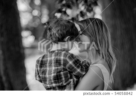 mother holds son on a hands at outdoor  54058842