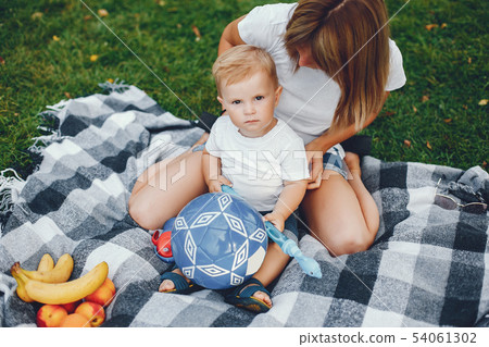 Mother with son playing in a summer park Mother with son playing in a summer park 54061302