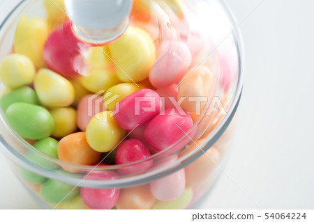 close up of glass jar with colorful candy drops close up of glass jar with colorful candy drops 54064224
