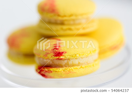 close up of yellow macarons on confectionery stand close up of yellow macarons on confectionery stand 54064237