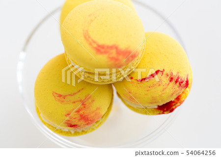 close up of yellow macarons on confectionery stand close up of yellow macarons on confectionery stand 54064256