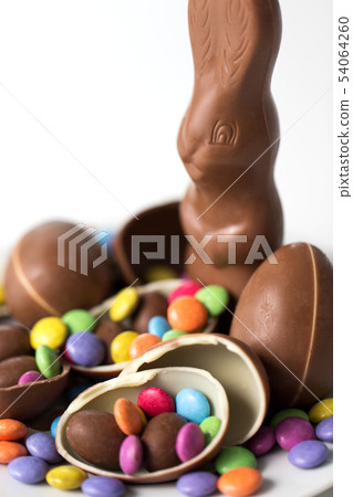close up of chocolate bunny, eggs and candy drops close up of chocolate bunny, eggs and candy drops 54064260