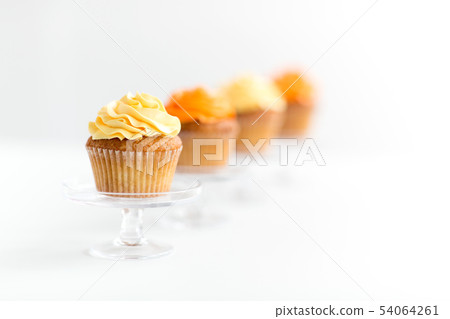 cupcakes with frosting on confectionery stands 54064261