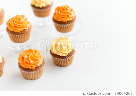 cupcakes with frosting on confectionery stands cupcakes with frosting on confectionery stands 54064265
