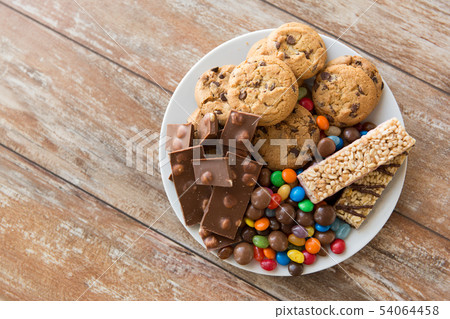 chocolate, cookies, candies and muesli bars chocolate, cookies, candies and muesli bars 54064458