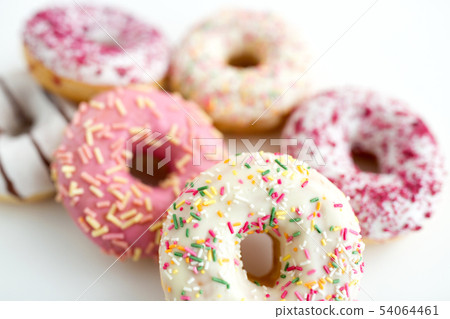 close up of glazed donuts on white table 54064461