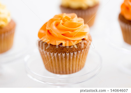 cupcake with frosting on confectionery stand 54064607