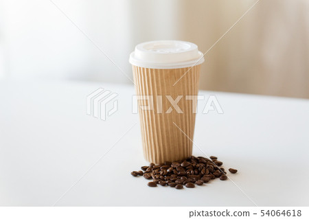 close up cup and roasted coffee beans on table close up cup and roasted coffee beans on table 54064618
