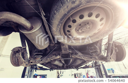 car on lift at repair station car on lift at repair station 54064640