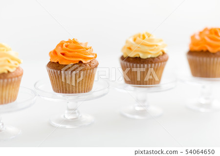 cupcakes with frosting on confectionery stands cupcakes with frosting on confectionery stands 54064650