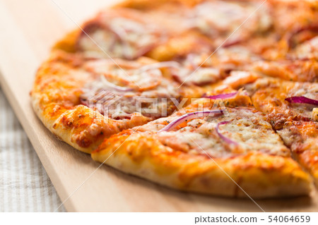 close up of homemade pizza on wooden table 54064659