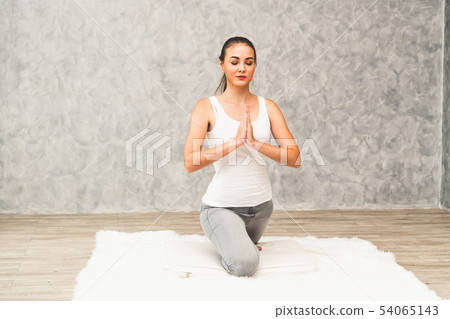 Young woman yoga on carpet at home living room. 54065143