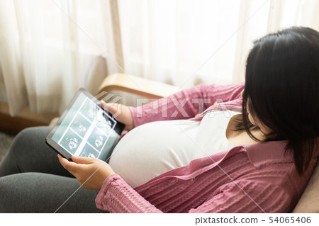 Happy pregnant woman and expecting baby at home. Happy pregnant woman and expecting baby at home. 54065406