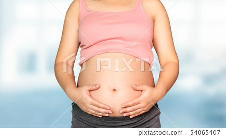 Pregnant woman at hospital health check up. Pregnant woman at hospital health check up. 54065407