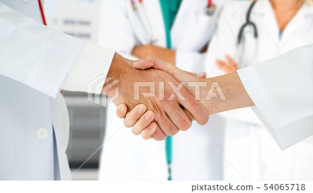 Doctor working in hospital with other doctors. Doctor working in hospital with other doctors. 54065718