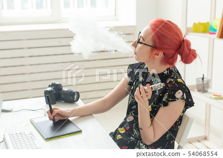 graphic designer concept - Female graphic designer working on computer while using graphic tablet at 54068554