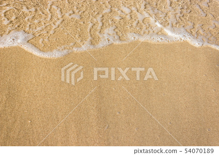Soft waves with foam of ocean on the sandy beach Soft waves with foam of ocean on the sandy beach 54070189