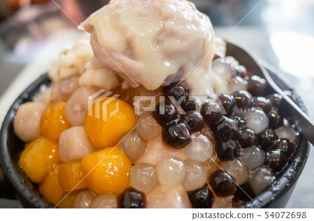 eating shaved ice with colorful dessert 54072698