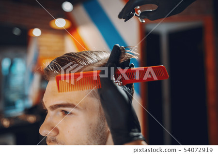 Stylish man sitting in a barbershop Stylish man sitting in a barbershop 54072919