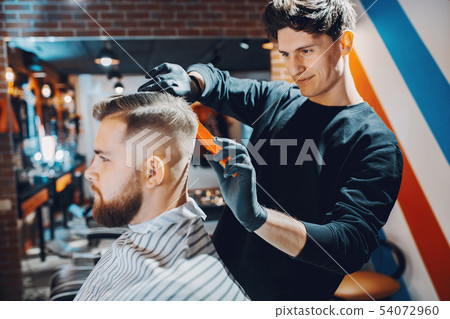 Stylish man sitting in a barbershop 54072960