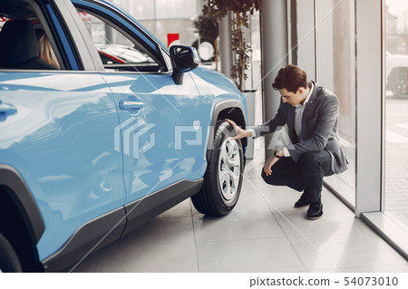 Handsome and elegant man in a car salon Handsome and elegant man in a car salon 54073010