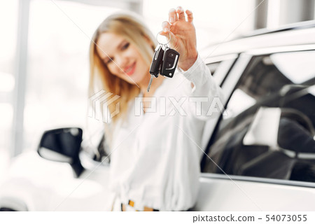 Stylish and elegant woman in a car salon 54073055