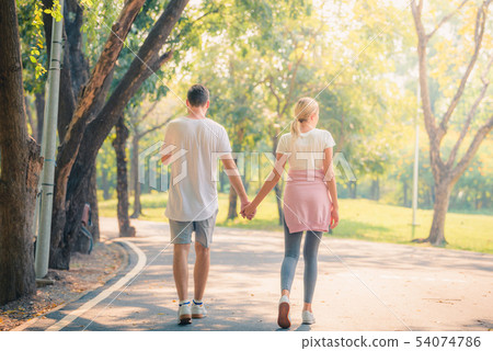 Portrait of Young couple enjoying in the park at Portrait of Young couple enjoying in the park at 54074786