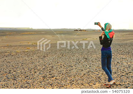Young woman takes a selfie on her smartphone on Young woman takes a selfie on her smartphone on 54075320