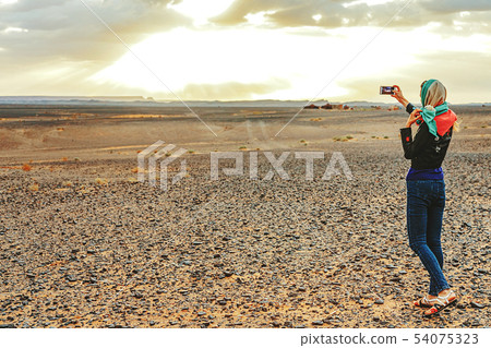 Young woman takes a selfie on her smartphone on Young woman takes a selfie on her smartphone on 54075323