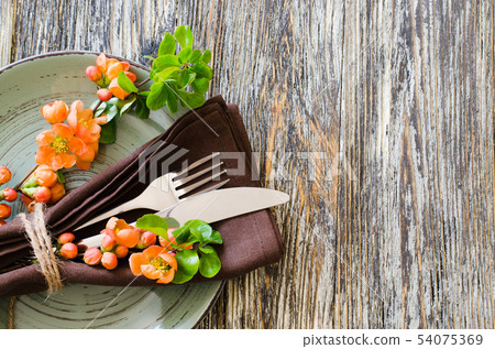 Vintage table setting with delicate flowers on rustic shabby table. 54075369