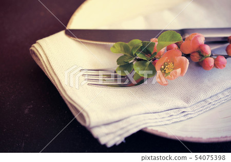 Vintage table setting with delicate flowers on a dark background Vintage table setting with delicate flowers on a dark background 54075398