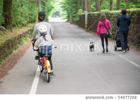 Parents riding a bicycle at Karuizawa Parents riding a bicycle at Karuizawa 54077208