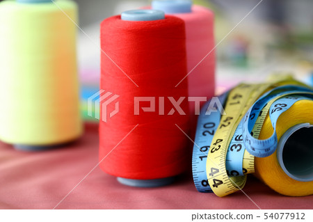 Thread coil background color on pink background 54077912