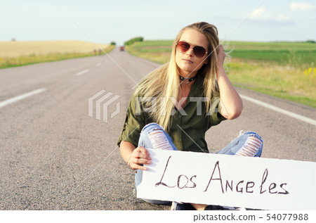 Beautiful Girl Hitchhiking On The Road Traveling. Beautiful Girl Hitchhiking On The Road Traveling. 54077988
