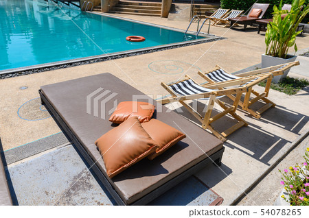 Mattress bed with wooden sunbeds on side of Mattress bed with wooden sunbeds on side of 54078265