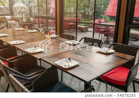 Wooden dining table and chairs in industrial 54078283