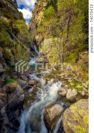 Nice small river and waterfall in valley 54078419