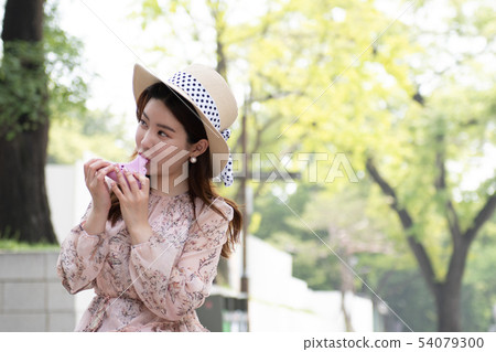 Women in pink ocarina blowing Women in pink ocarina blowing 54079300