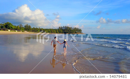 Happy Asian couple dating at the beach during Happy Asian couple dating at the beach during 54079481