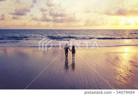 Happy Asian couple dating at the beach during Happy Asian couple dating at the beach during 54079484